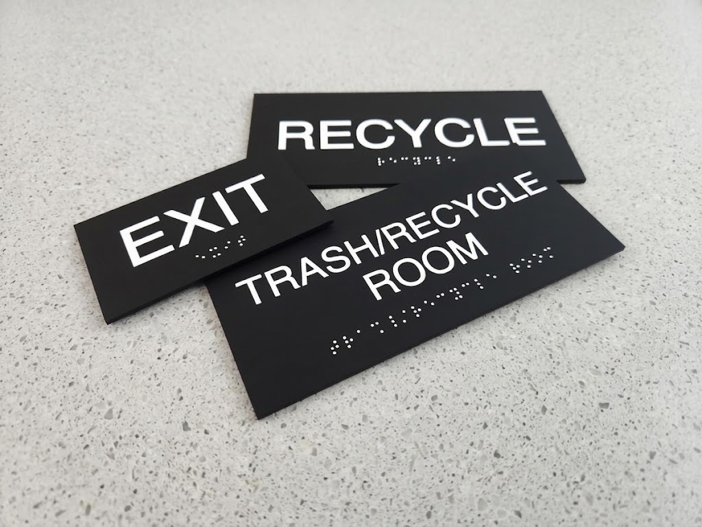 Black ADA room identification signs for Exit, Recycle, and Trash/Recycle Room with Grade 2 braille