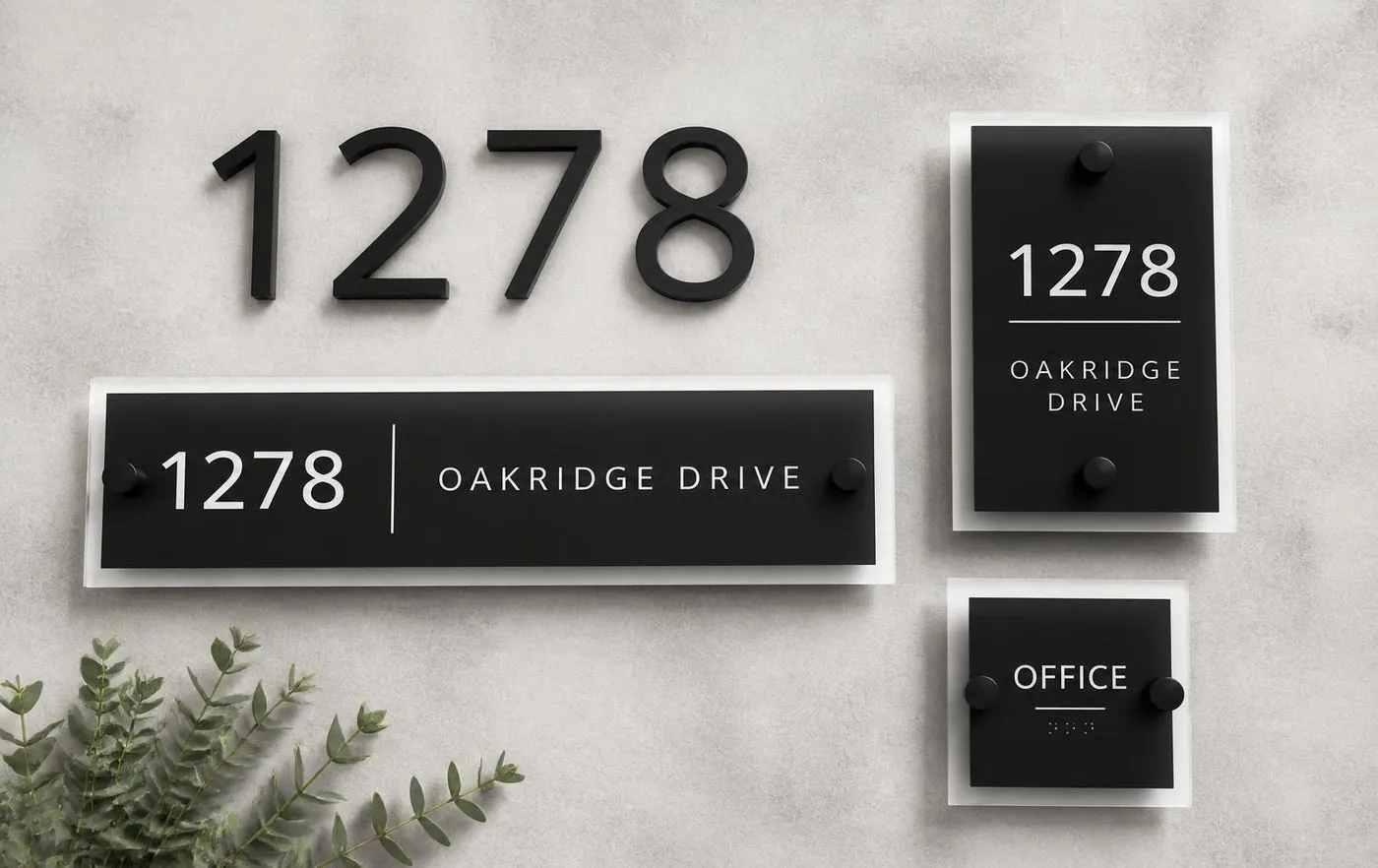 Address numbers, plaques and ADA signage arranged on concrete