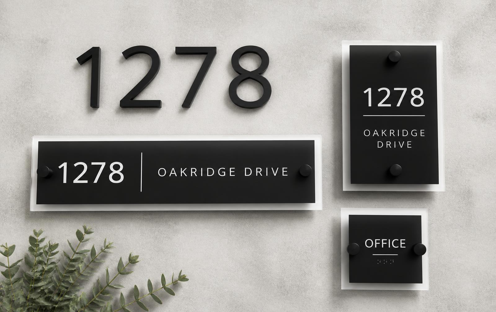 Address numbers, plaques and ADA signage arranged on concrete